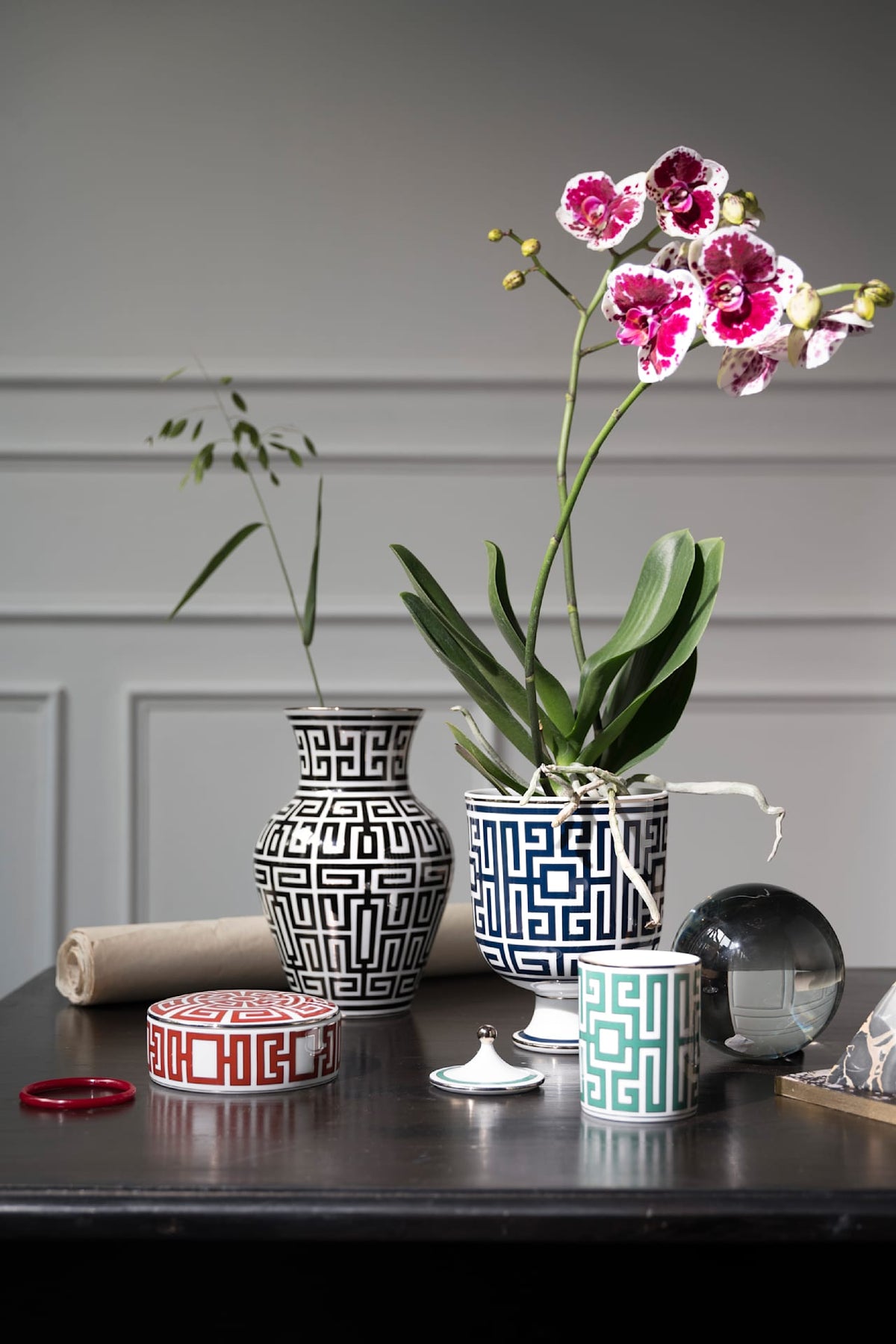 Ginori 1735 vases with a Greek key pattern and a pink orchid