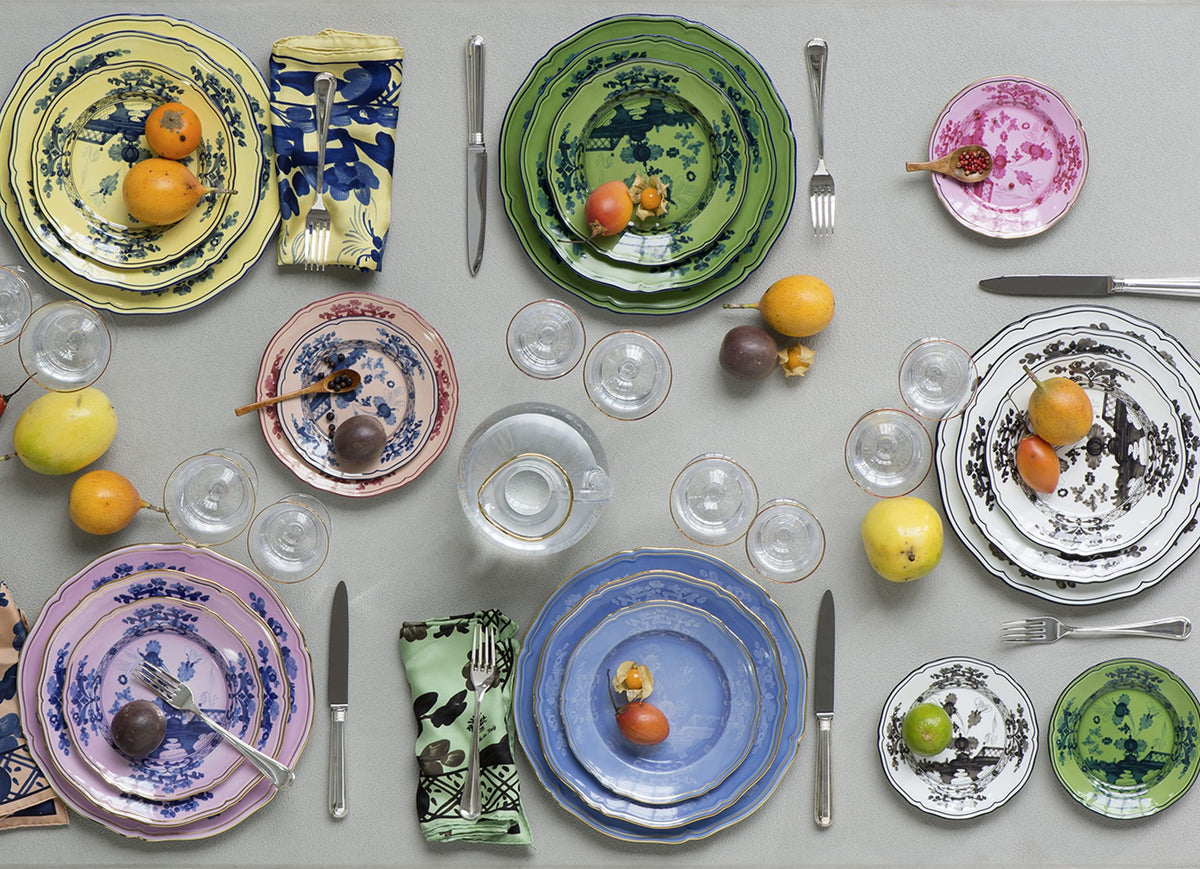 Ginori 1735 plates in many colours laid with fruit and glasses