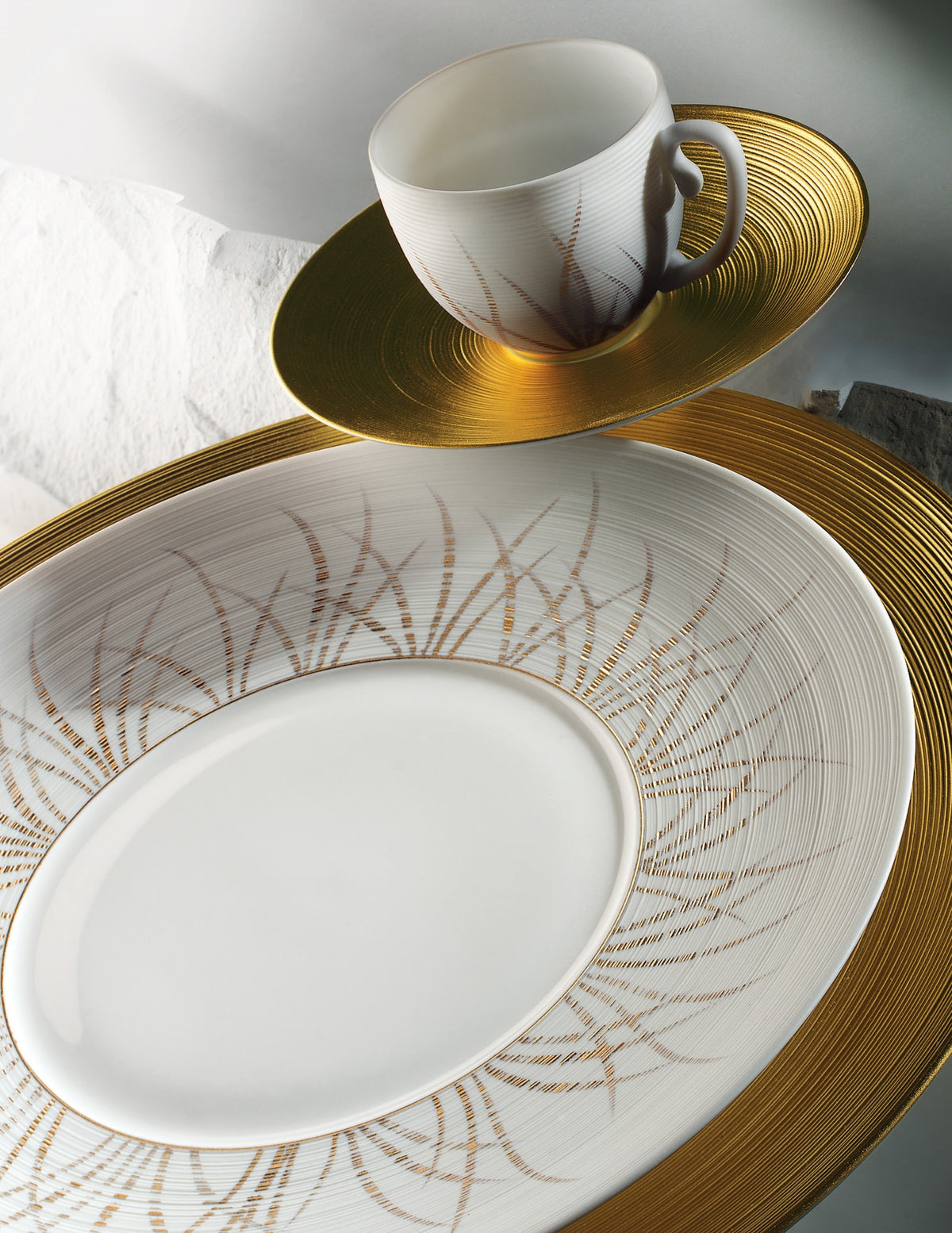 J.L. Coquet porcelain plate with gold radiating decor and a cup on a gold saucer