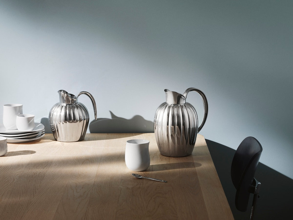 Georg Jensen stainless steel pitchers on a sunlit table