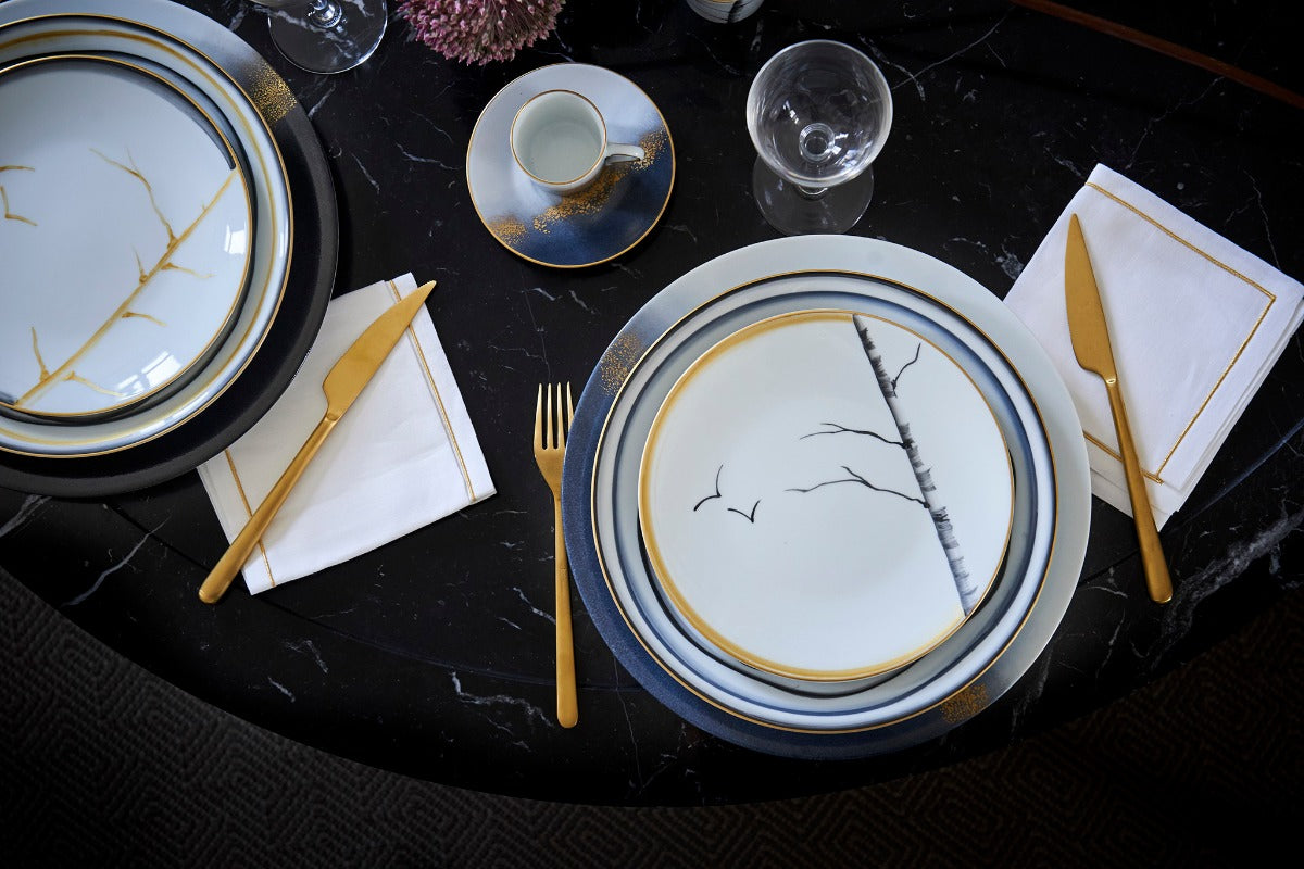 Table set with Marie Daâge plates painted with branches and gold rims