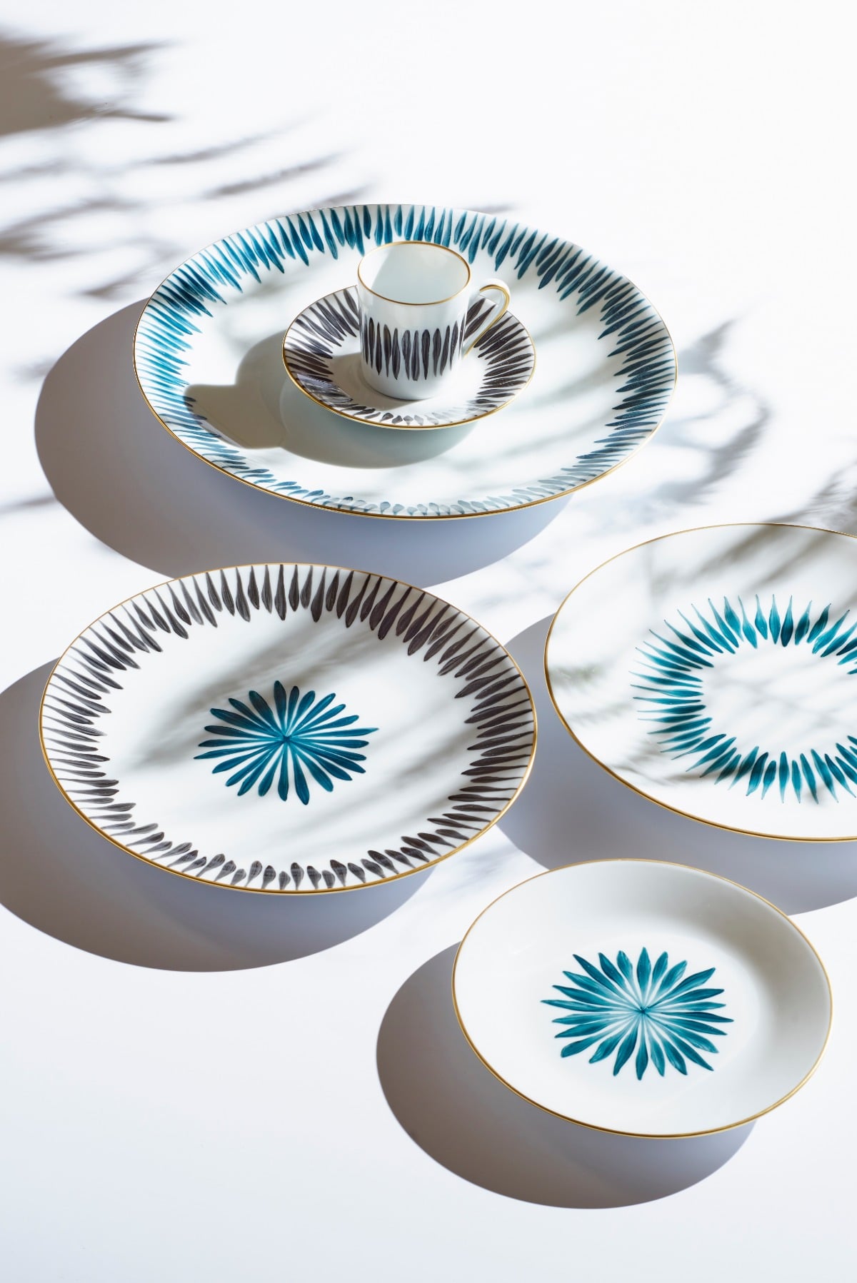 Marie Daâge plates and cup hand-painted with blue starburst motifs