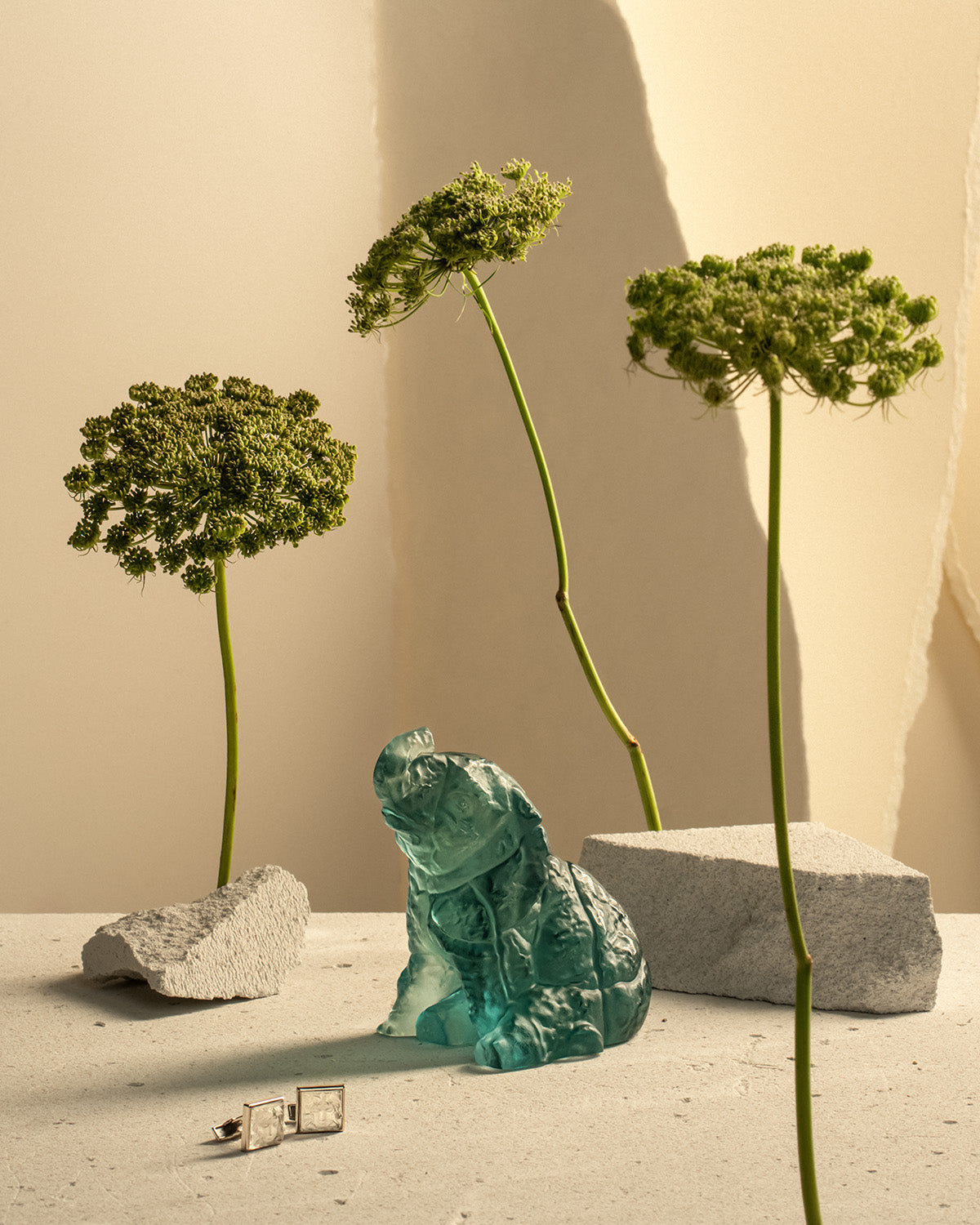 Blue-green Lalique crystal bear among dried flowers