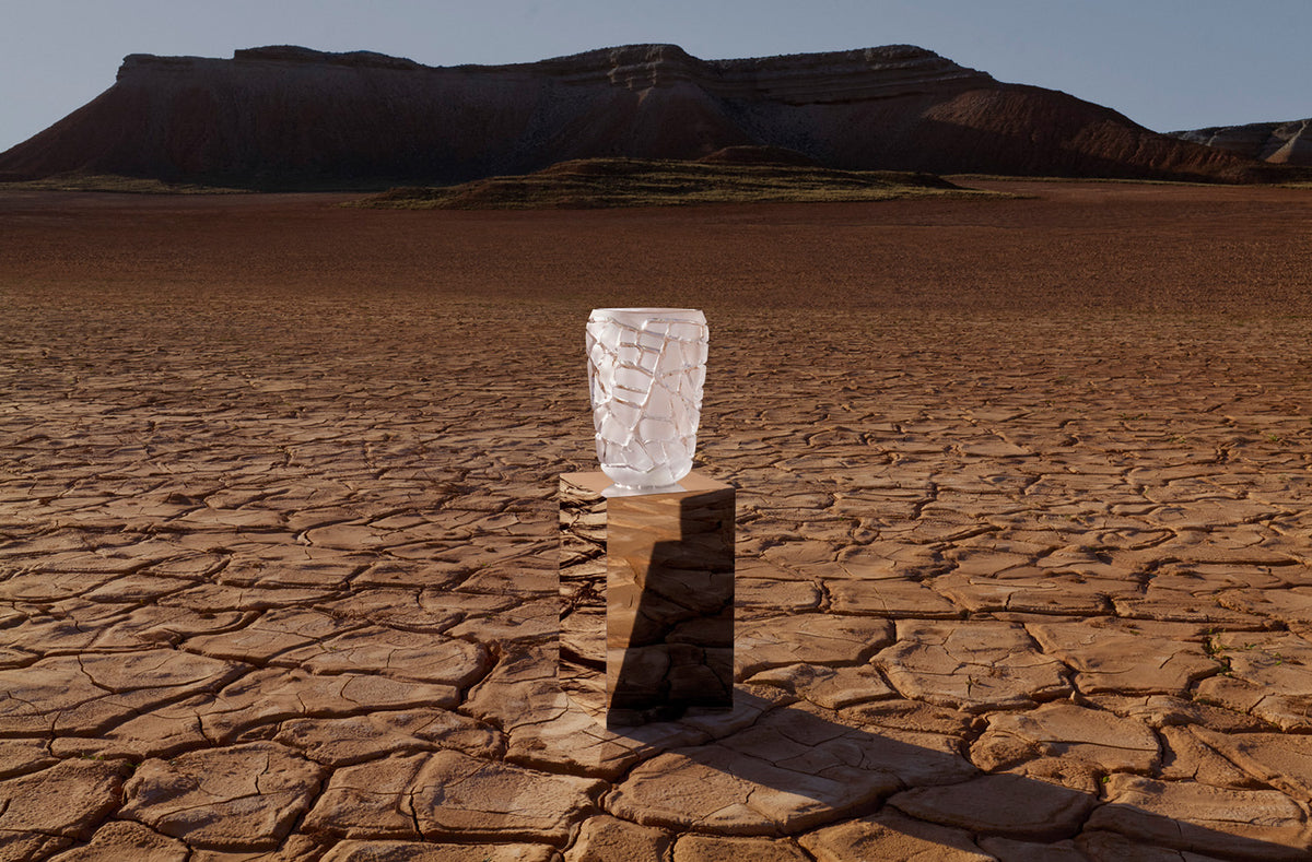 Lalique crystal vase on a plinth in a desert landscape