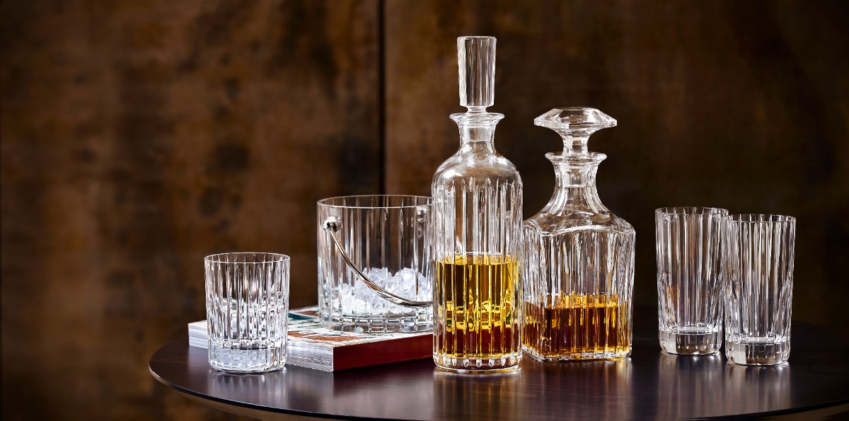 Baccarat crystal barware: two decanters, tumblers, highball glasses and an ice bucket