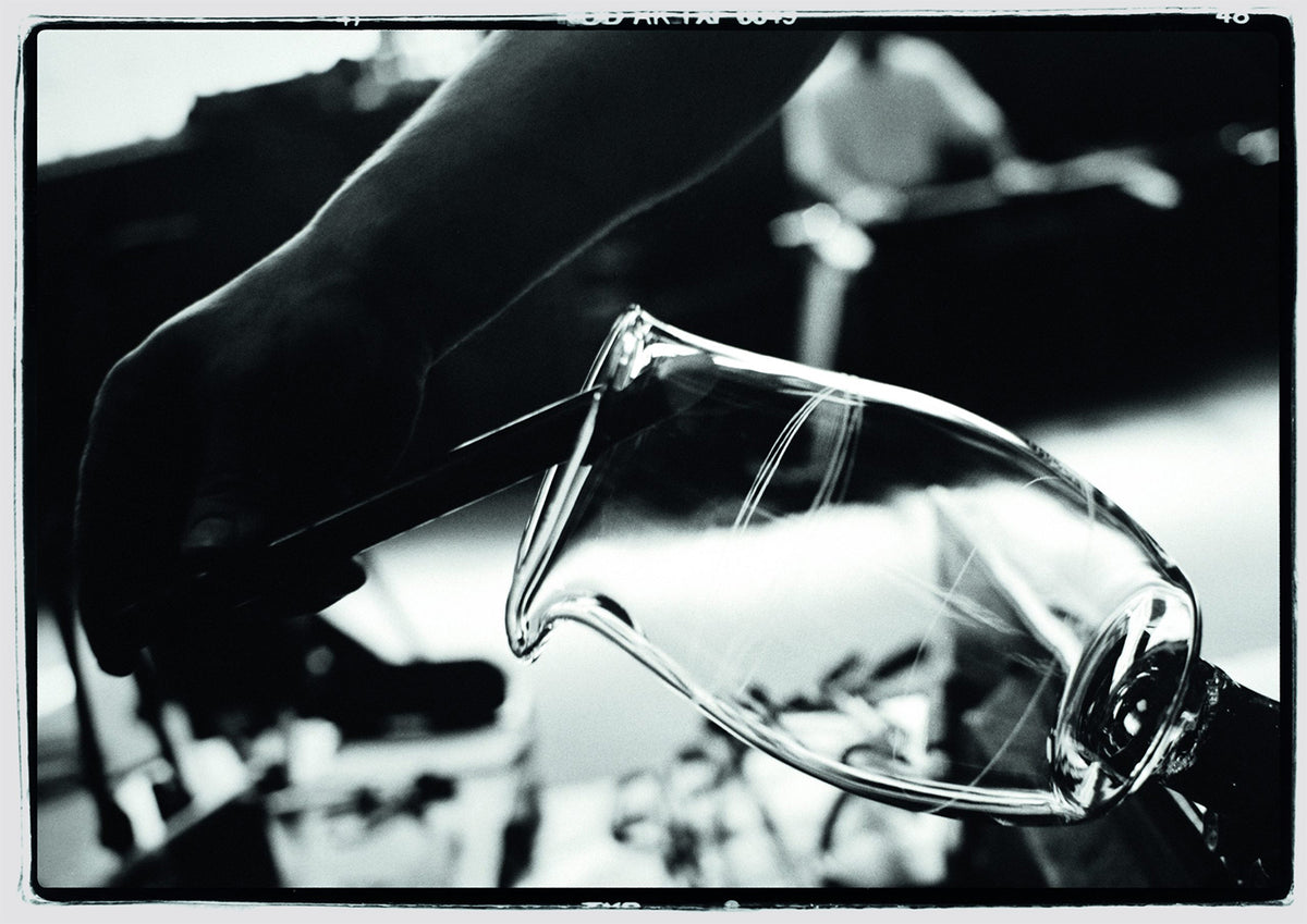 Baccarat craftsman working on a crystal vessel by hand