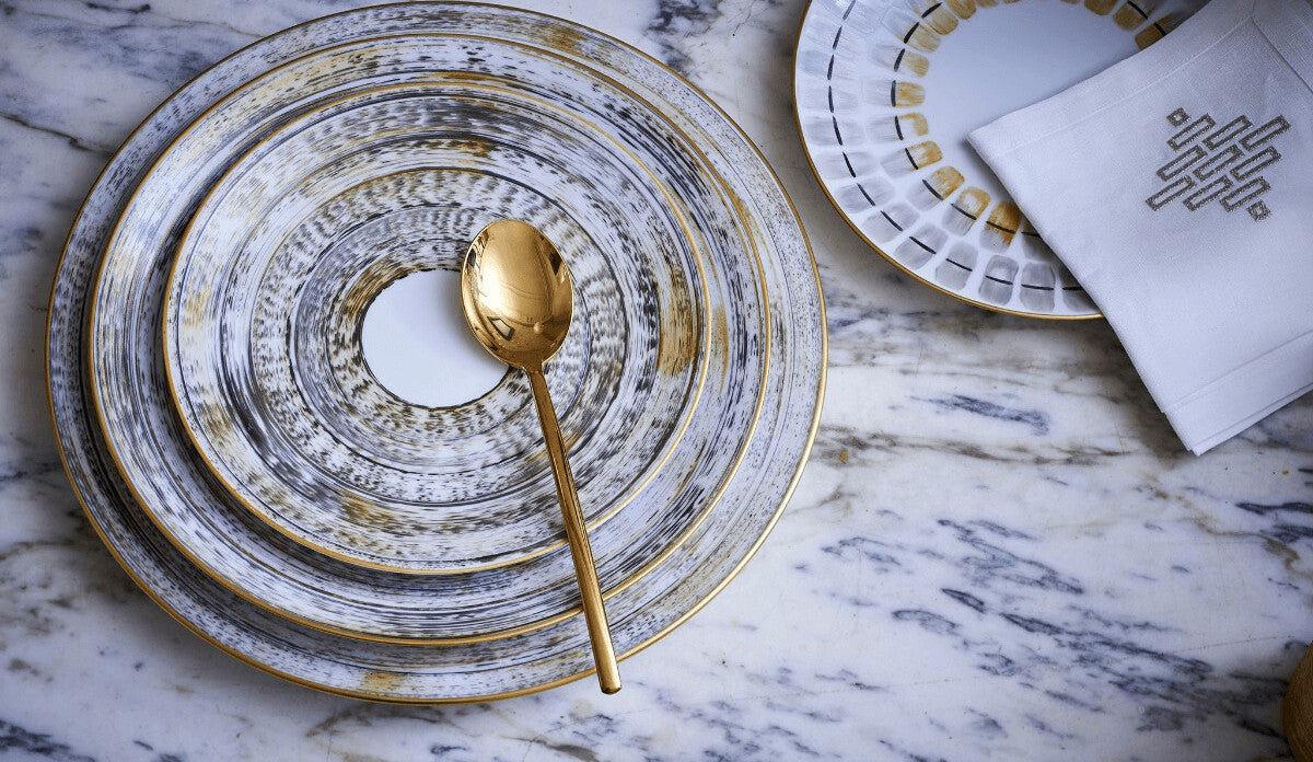 Brushed-gold plates with a gold spoon