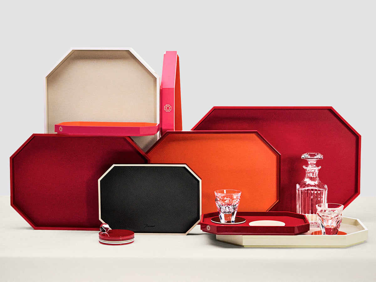Baccarat Octogone lacquered trays in red, orange, black and ivory, styled with crystal glasses and a decanter