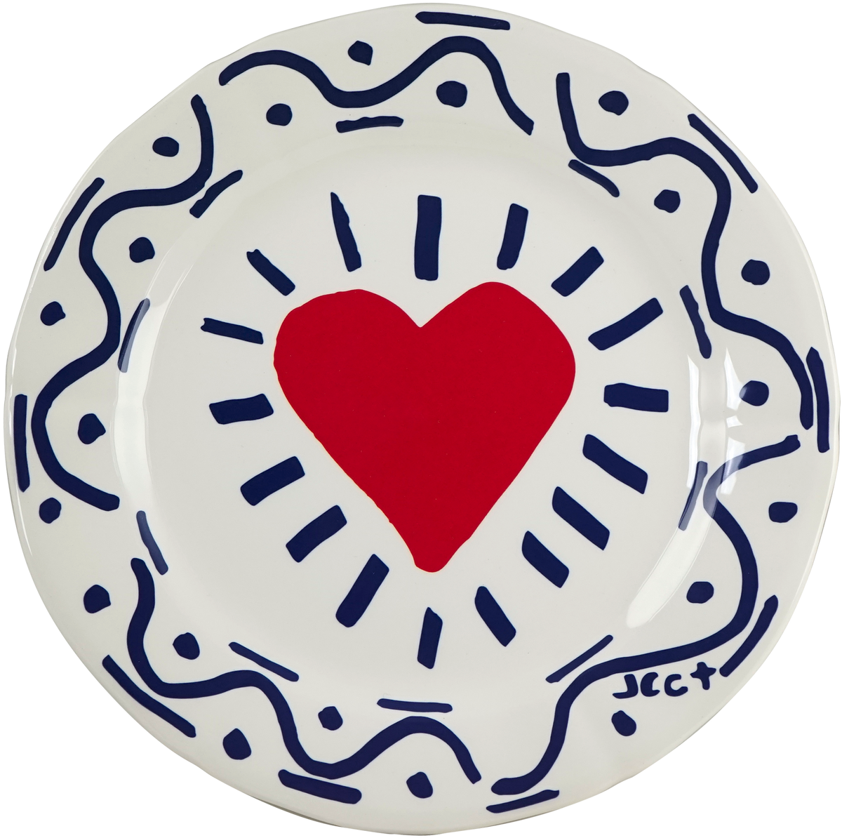 A Gien plate from L'Archipel Sentimental by Jean-Charles de Castelbajac, with a red heart and navy brushstrokes