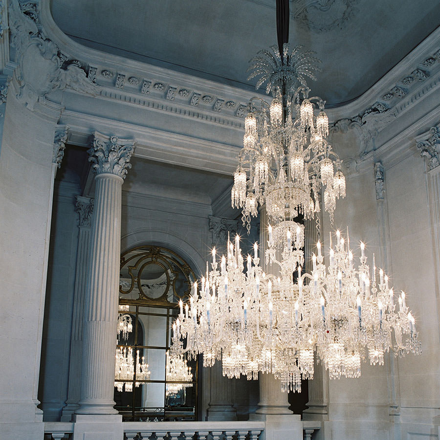 Grand Baccarat crystal chandelier in a classical hall with columns