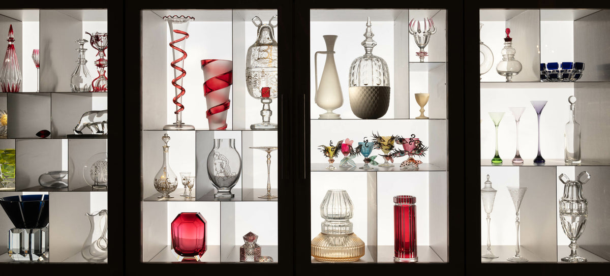 Display cabinets of Baccarat crystal decanters, vases and coloured glassware