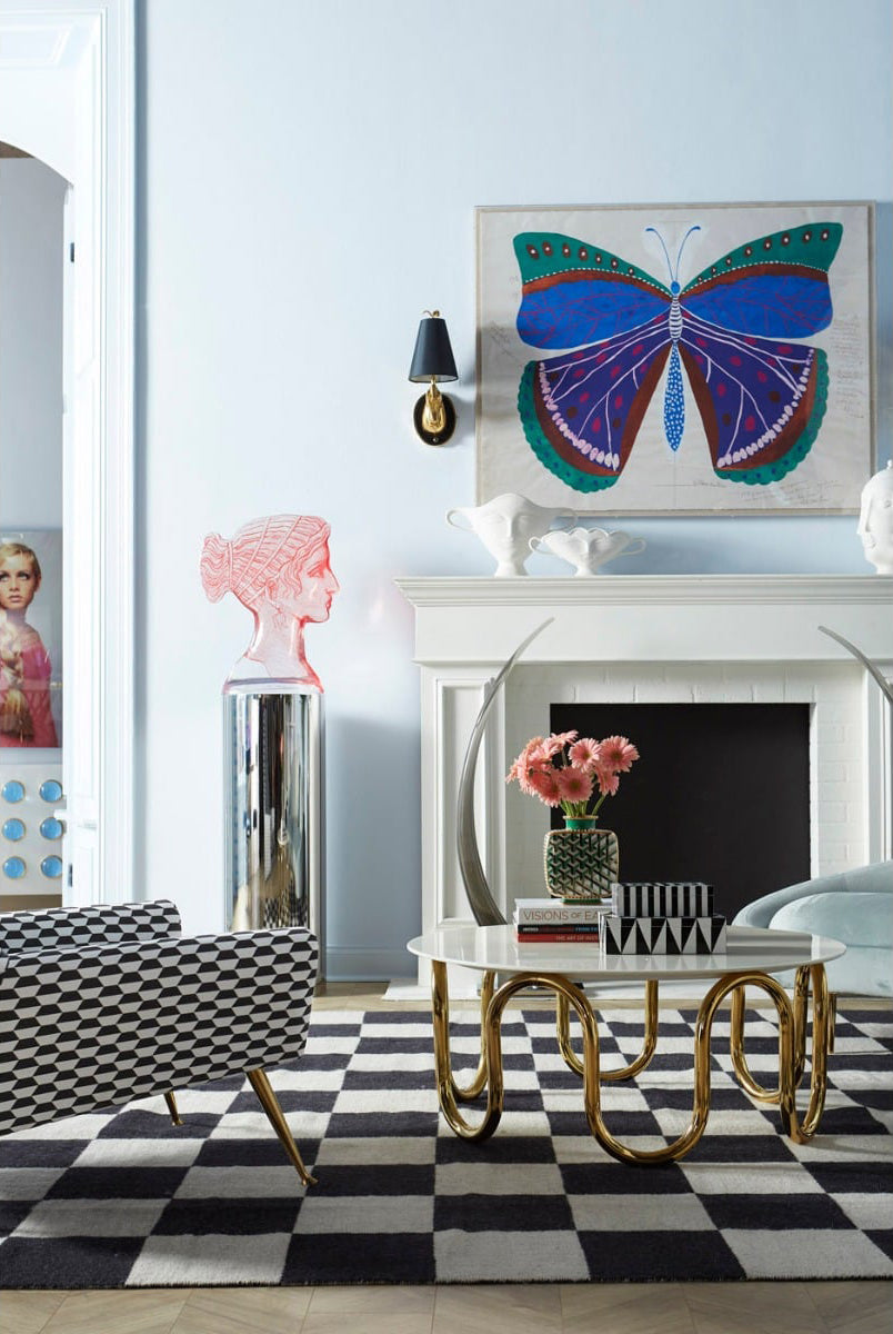 Living room with Jonathan Adler decor, a brass coffee table and a butterfly artwork
