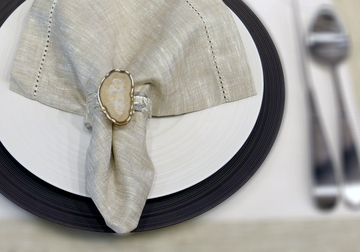 J.L. Coquet porcelain place setting with a linen napkin