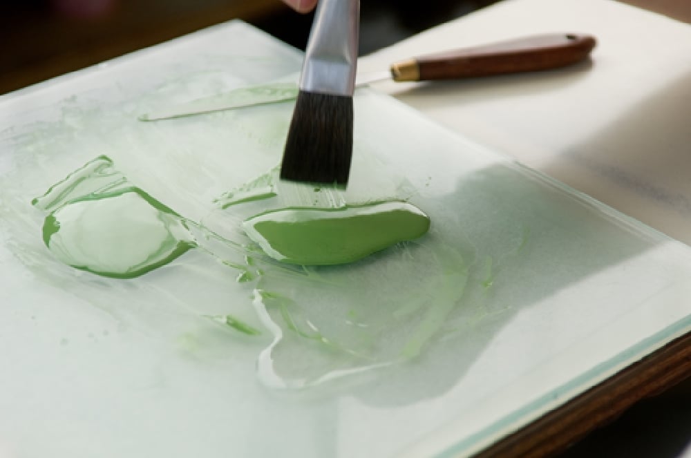 Brush applying green glaze in the Seignolles workshop