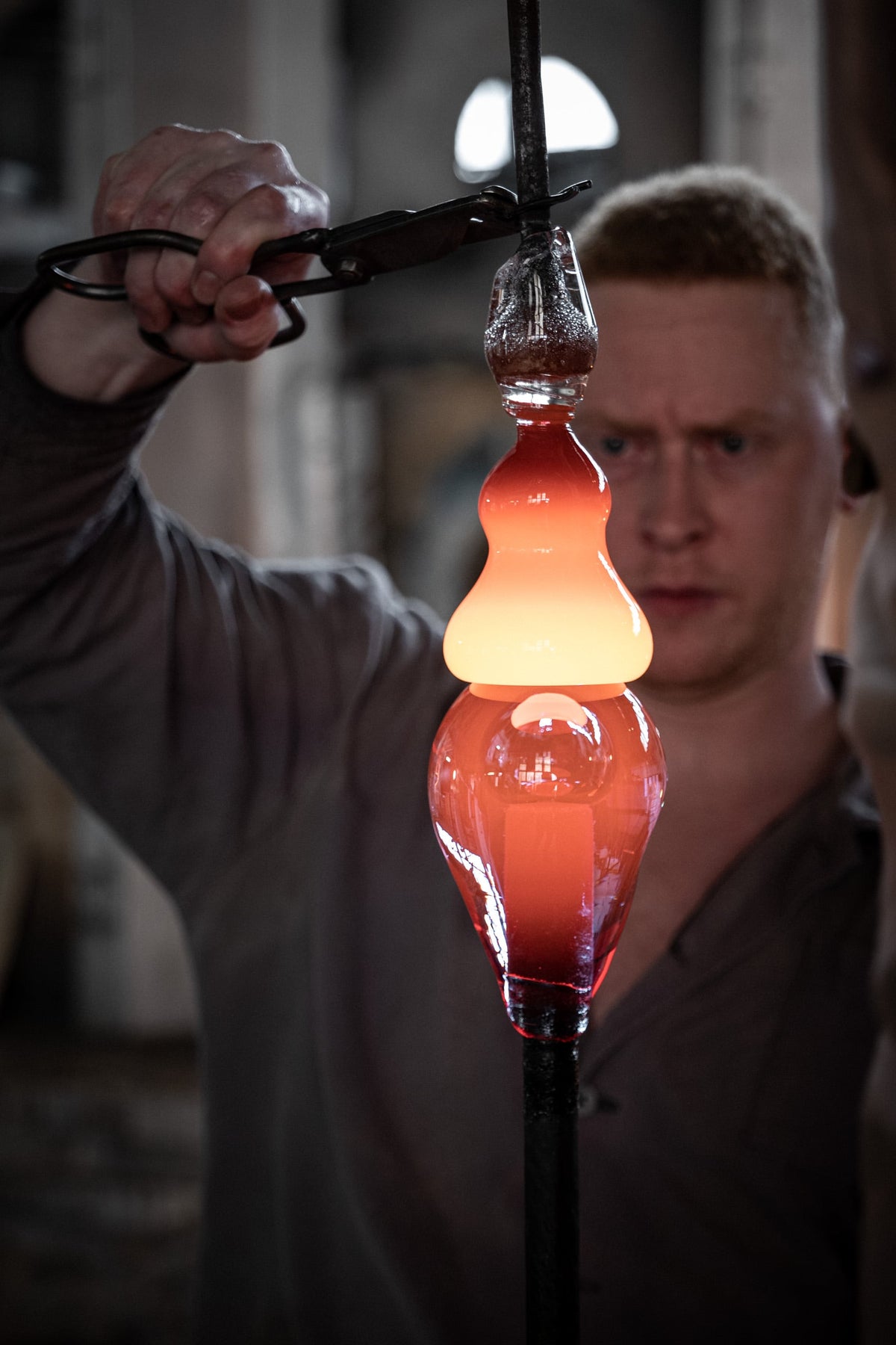 Moser glassblower shaping molten glass