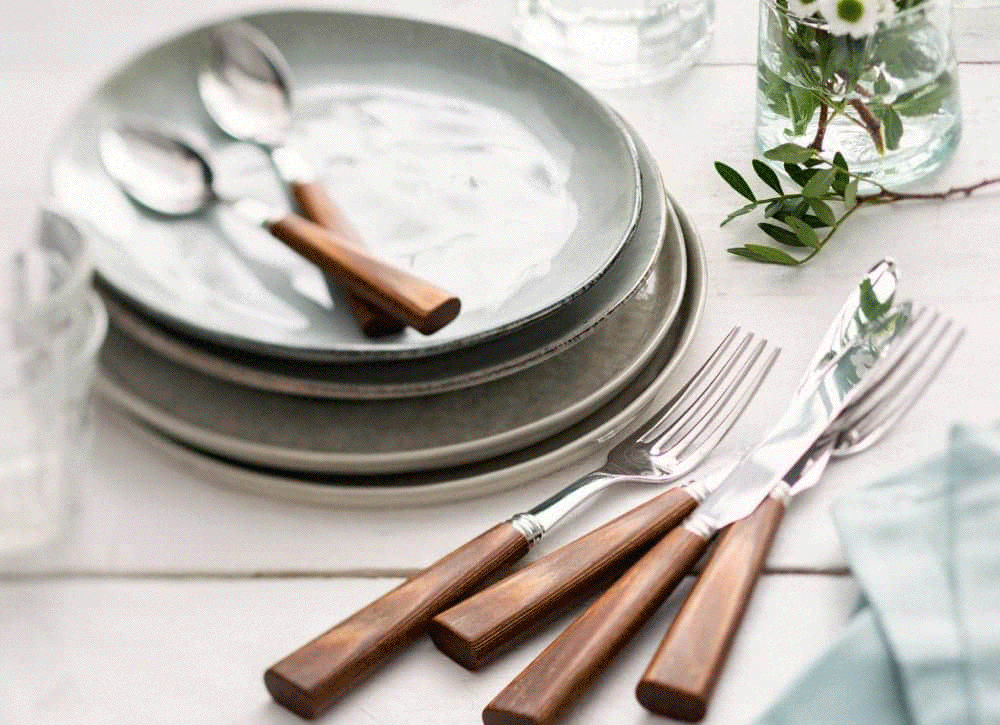 Sabre cutlery with wooden handles on stacked grey plates