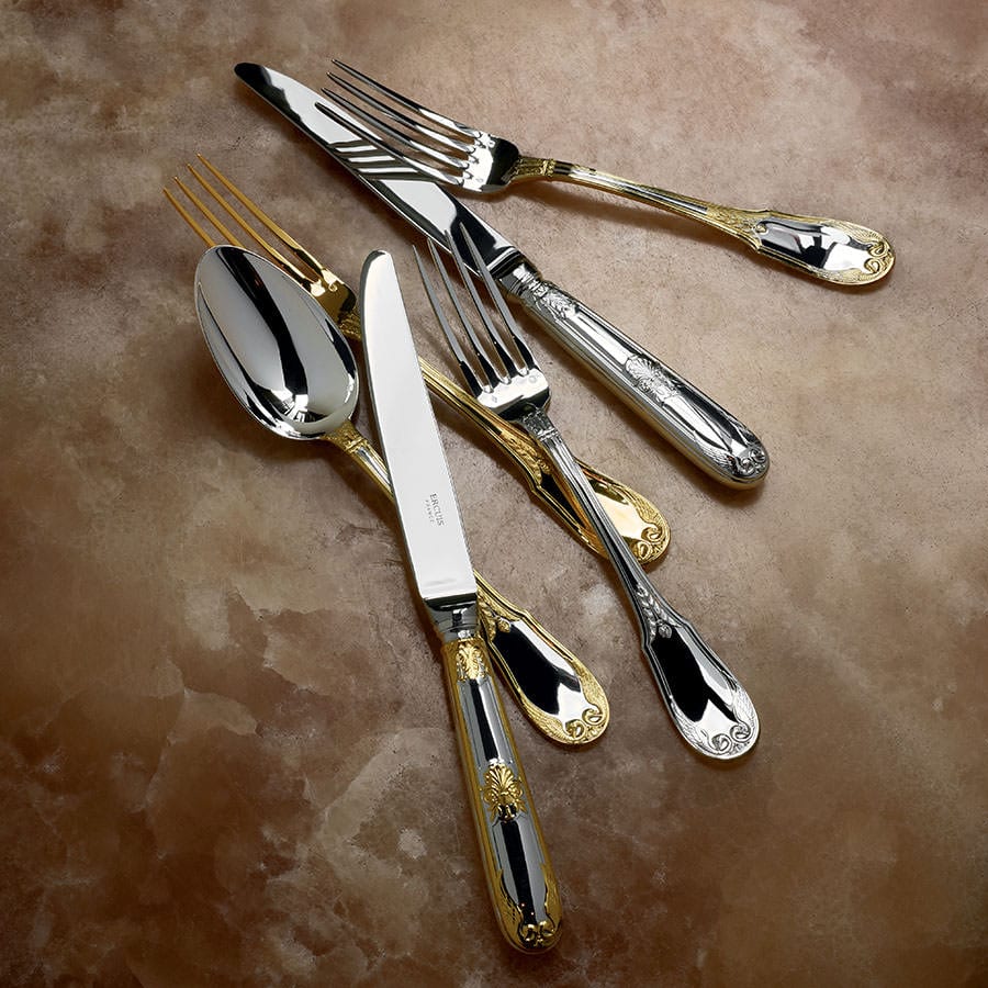 Ercuis silver cutlery with gilded details on a marbled background