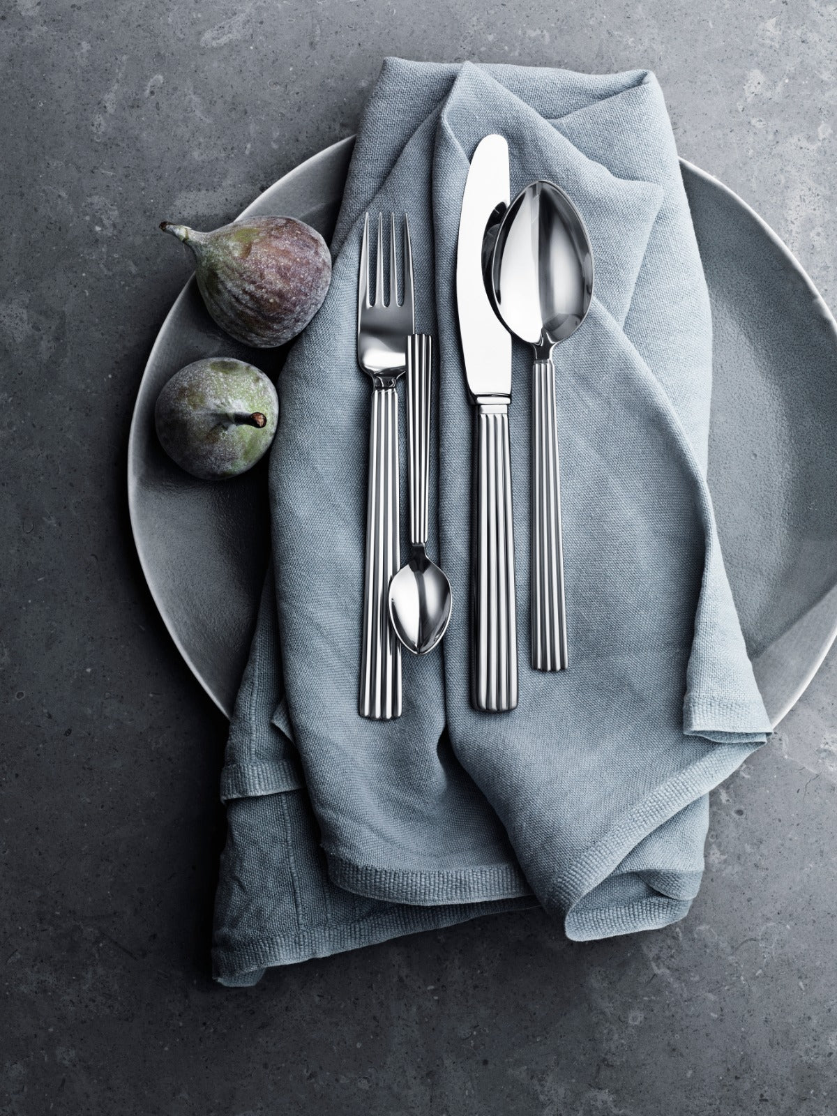 Georg Jensen cutlery with ribbed handles on a grey napkin