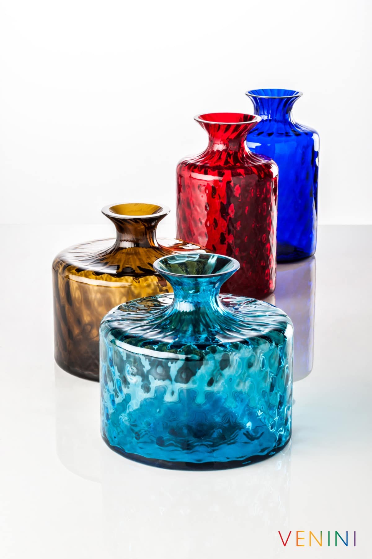 Venini Monofiori Carnevale bottles in amber, red, blue and turquoise glass