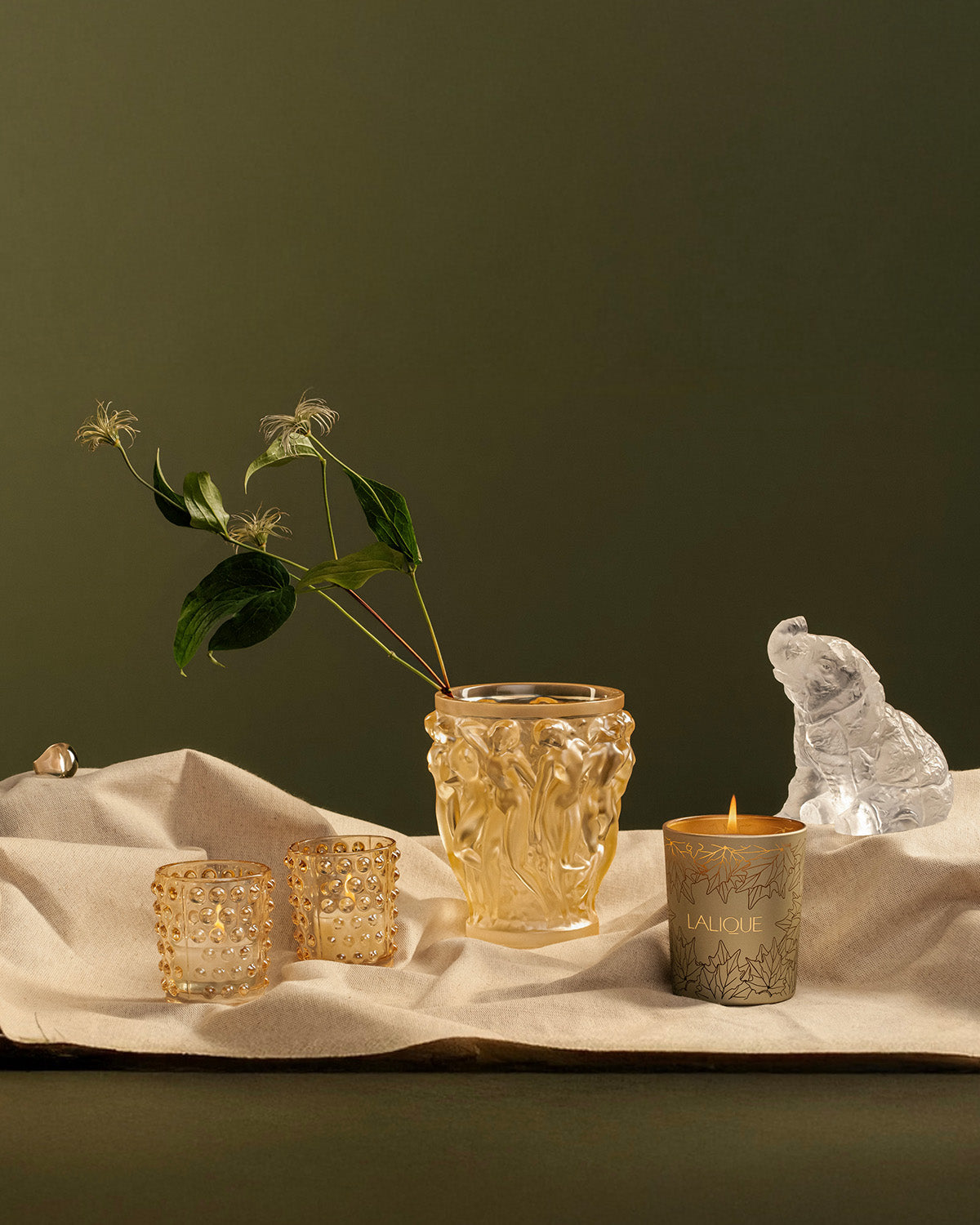 Gold Lalique crystal vase, votives, a candle and a clear crystal bear