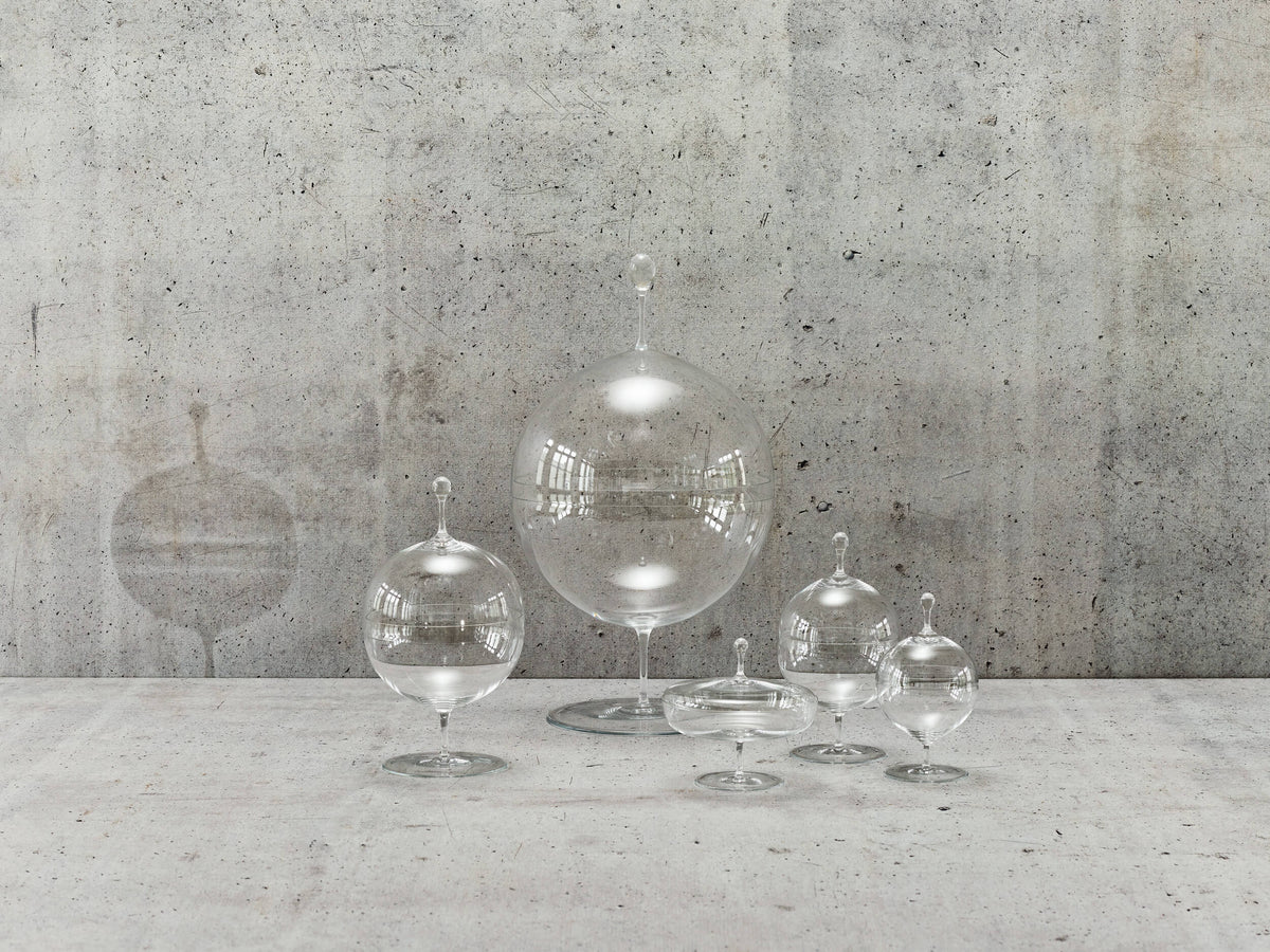 Delicate Lobmeyr blown glass vessels on a concrete shelf