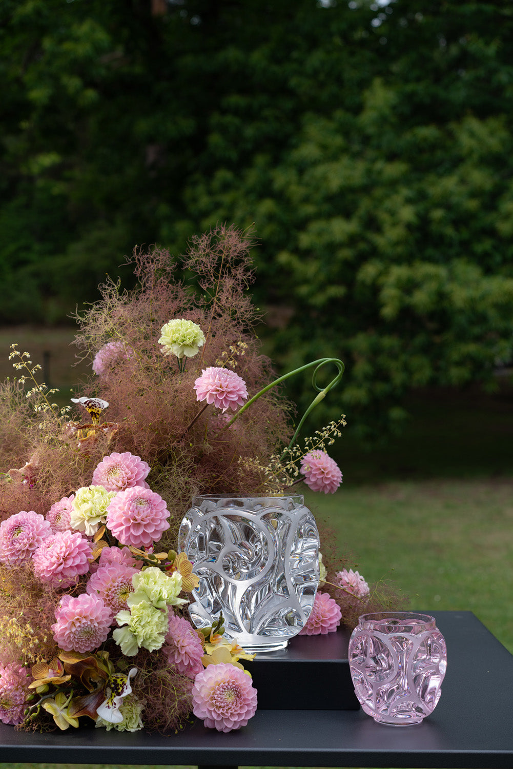 Clear and pink Lalique crystal vases with garden flowers