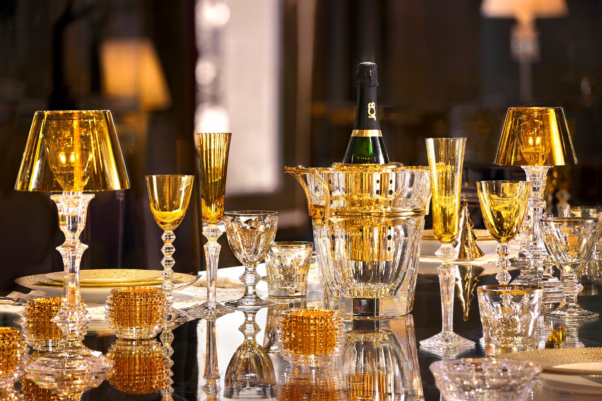 Table set with gold-tinted Baccarat crystal lamps, champagne flutes and glasses