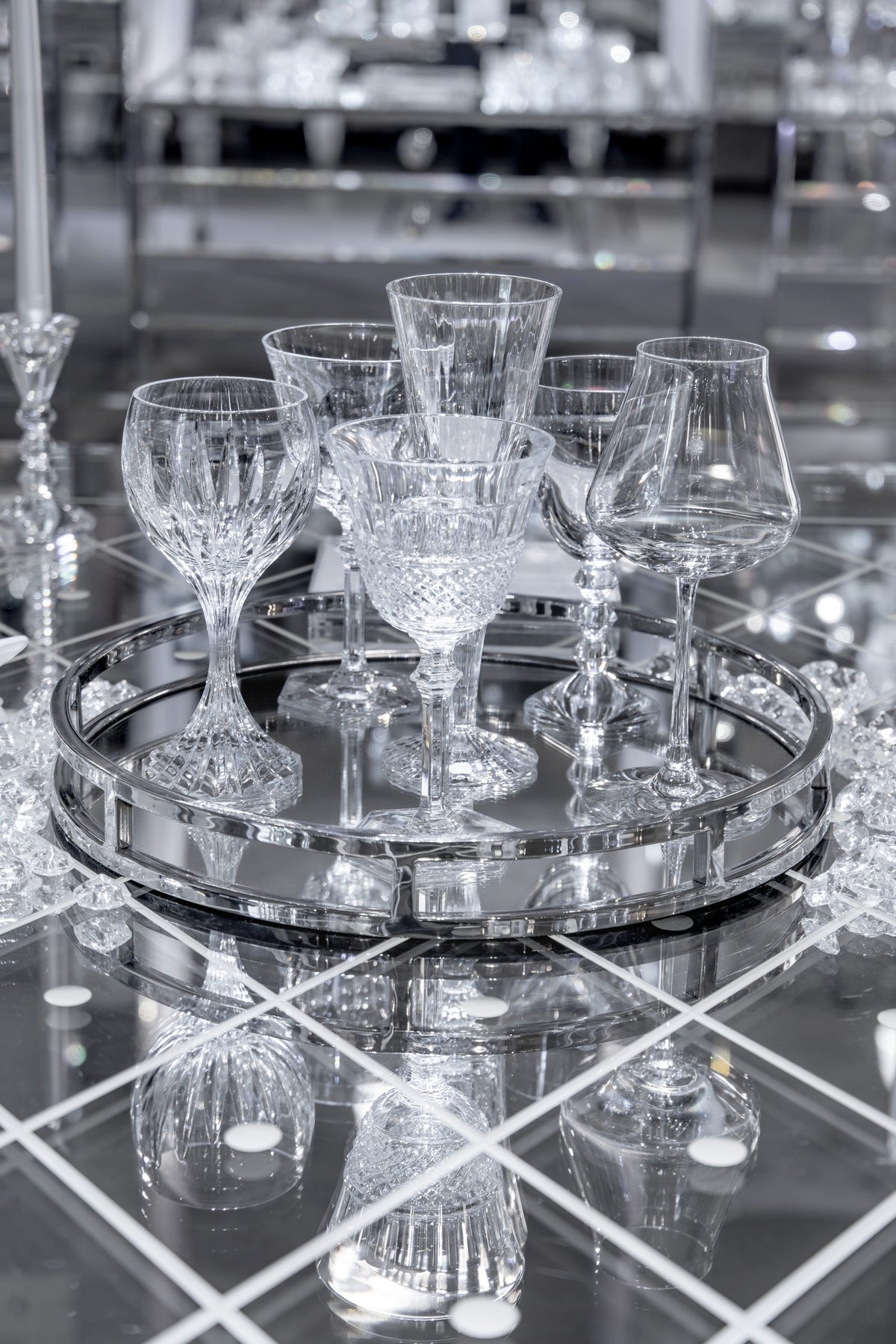 Baccarat crystal wine glasses on a round mirrored tray