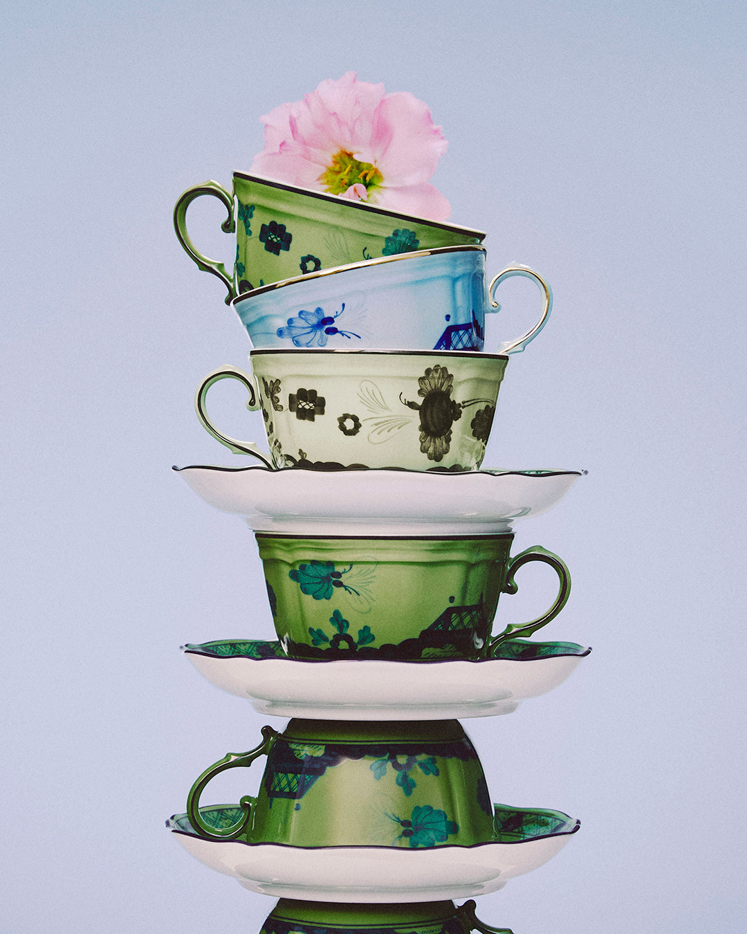 Stack of Ginori 1735 cups and saucers in green, blue and pink