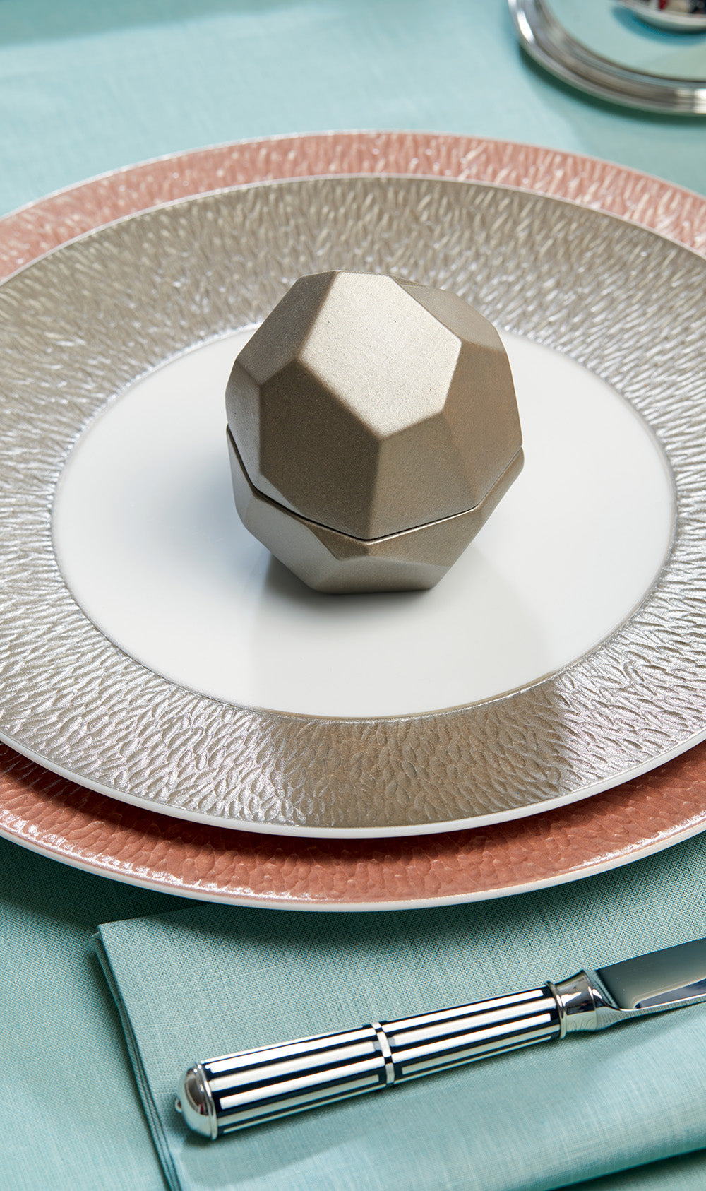Silver textured plate, faceted silver box and Ercuis knife on a turquoise cloth