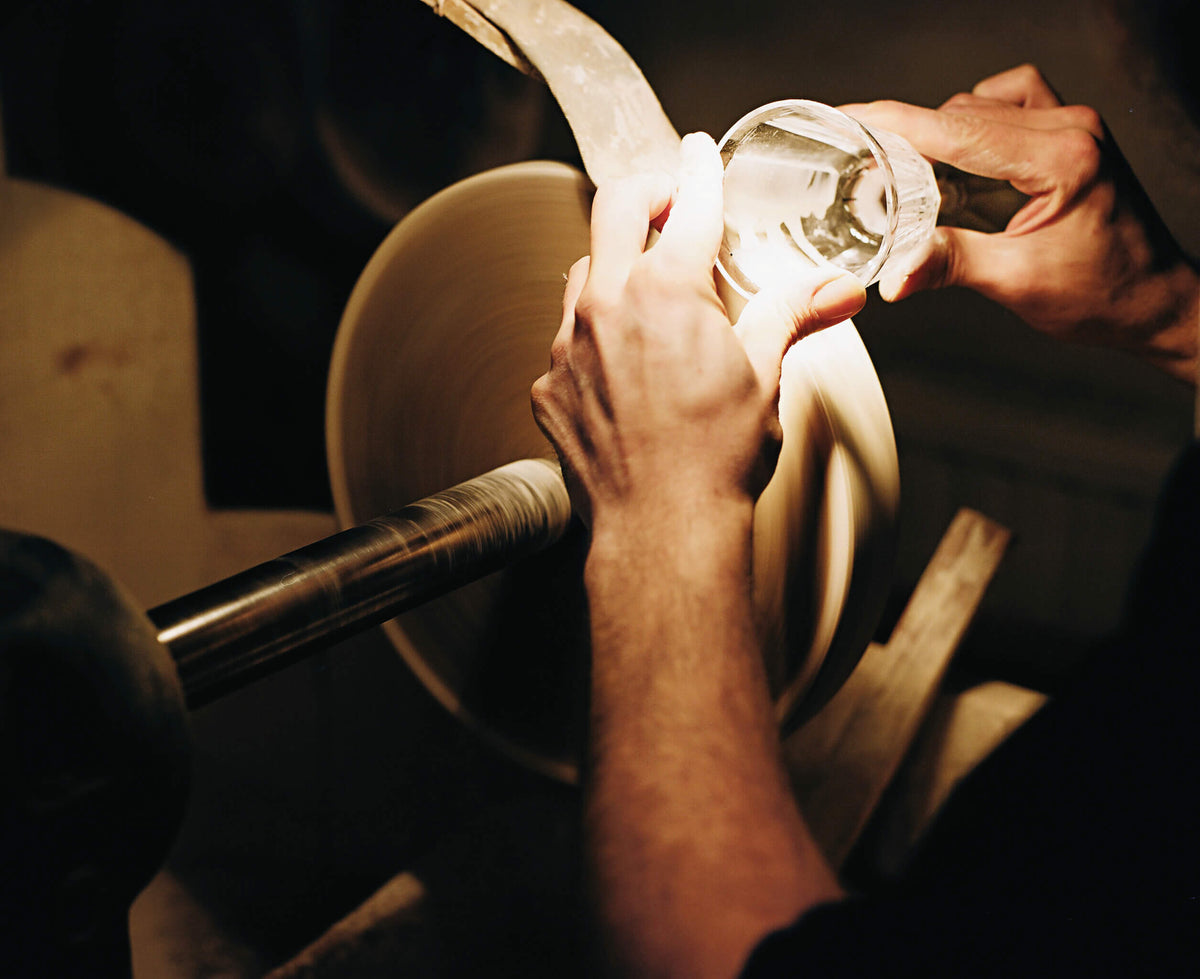 Lobmeyr craftsman engraving a glass at the wheel
